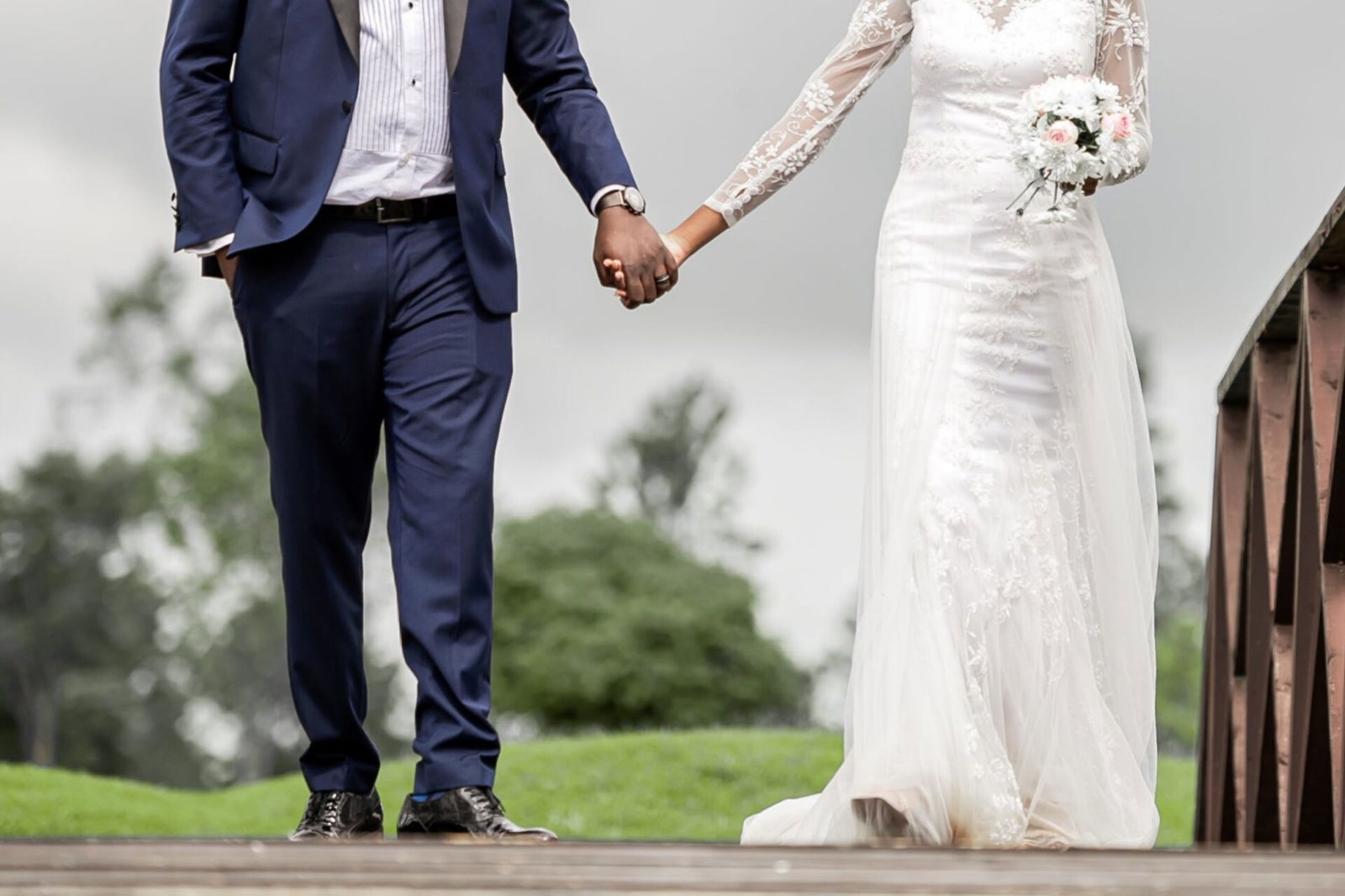 Married couple holding hands, wedding